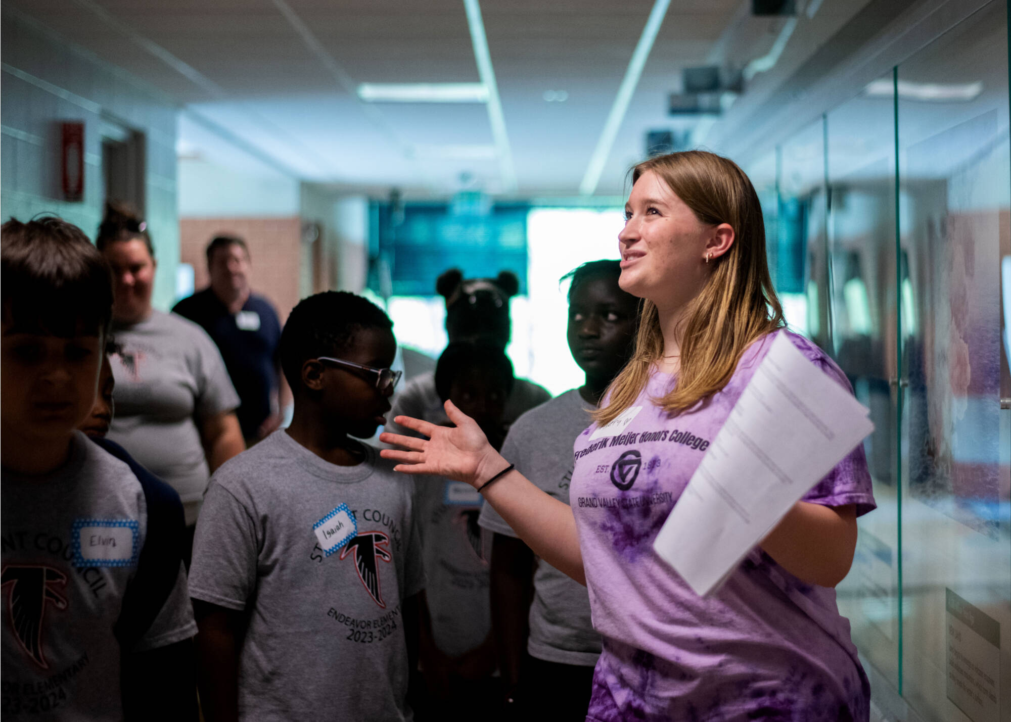 Frederik Meijer Honors College student Avery Meachum, center, talks with Kentwood’s Endeavor Elementary School students about the History of the Earth timeline in Padnos Hall of Science. The students were part of a multicultural leadership team that...